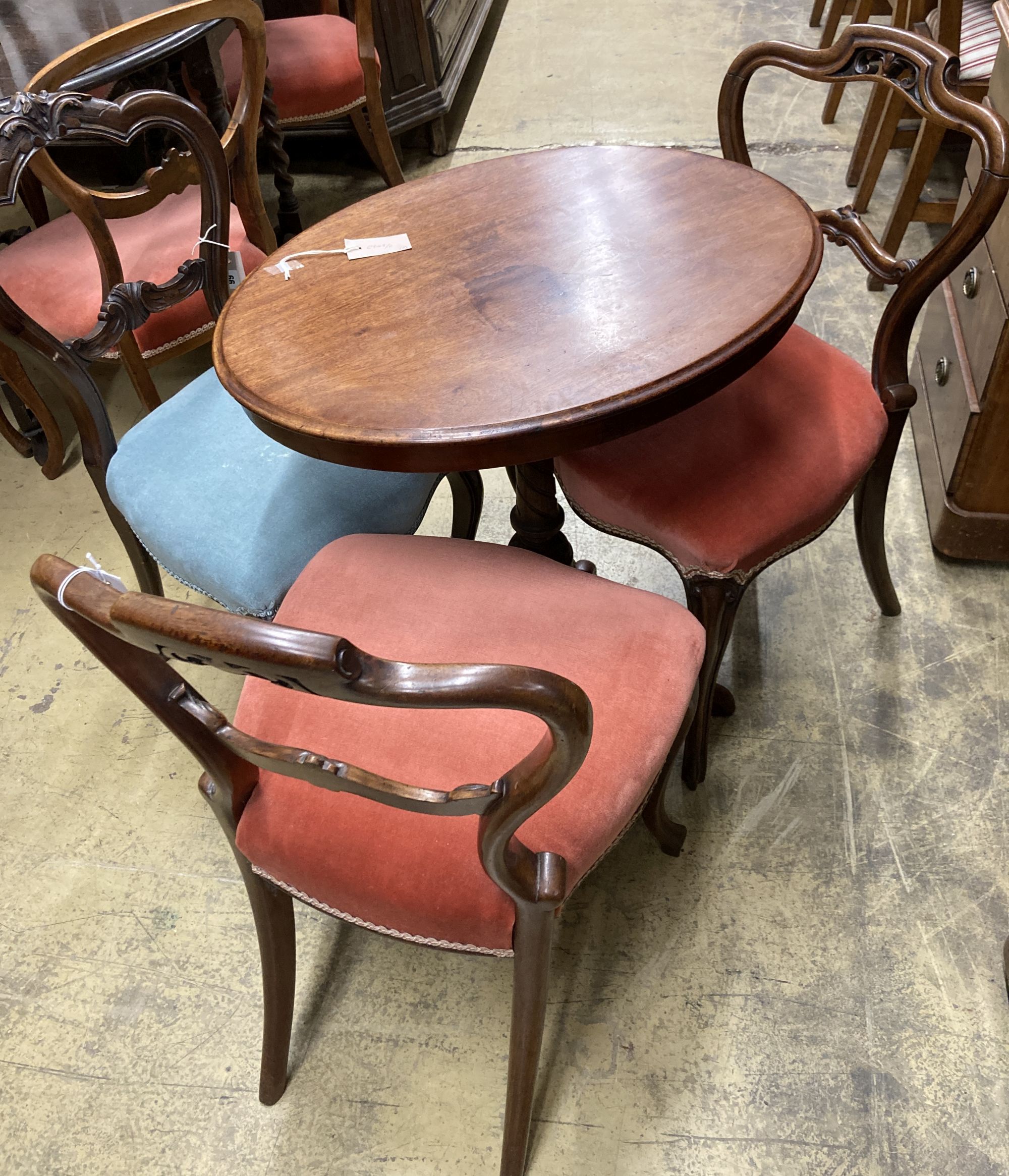 A Victorian oval tripod table, width 68cm, depth 52cm, height 72cm together with four Victorian spoon back dining chairs (three plus one)